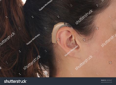 Beautiful Young Woman With Hearing Aid Closeup Shot Stock Photo