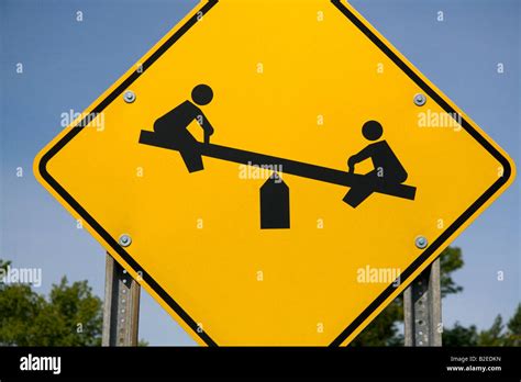 Road Sign Depicting A Seesaw Waring Of Children Playing In Gratiot