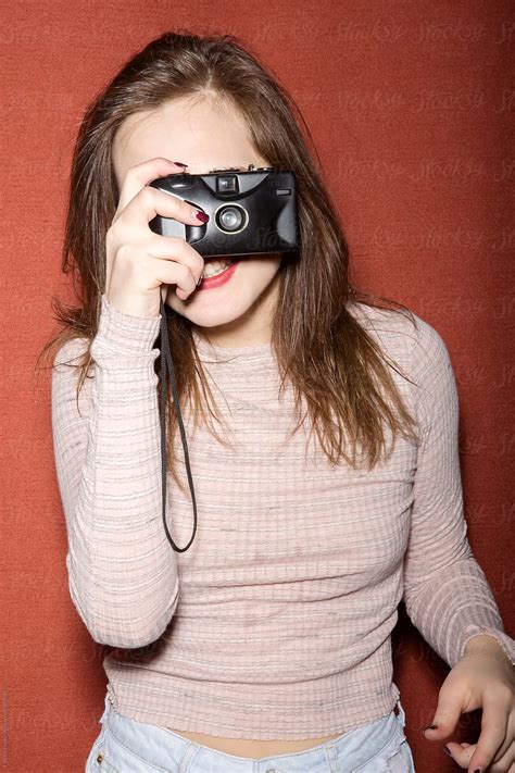 Cheerful Brunette Holding Film Camera In Front Of Her Face Del Colaborador De Stocksy Danil