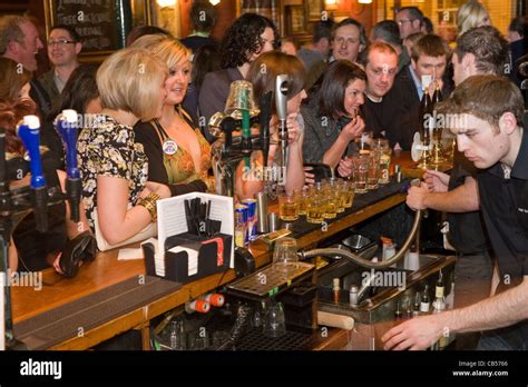 Busy Bar Filled With Young Males And Females Stock Photo Alamy