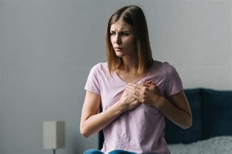 Young Woman Touching Her Chest In Pain At Home Free Photo