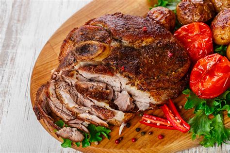 Set the meat on a rack set into a roasting pan. Roasted Pork Shoulder On The Bone With Potatoes Stock Photo - Download Image Now - iStock