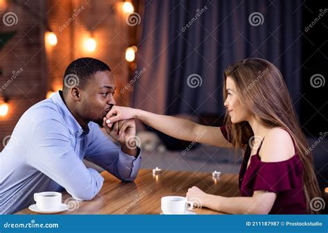 happy interracial couple flirting during romantic date in restaurant stock image image of