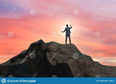 Businessman At The Top Of Mountain In Career Concept Stock Photo