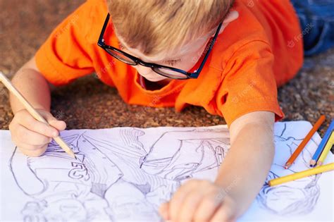 Premium Photo Almost Done Talented Little Boy Drawing An Incredibly