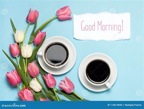 Two Cups Of Coffe And Pink Tulips On Blue Background Words Good