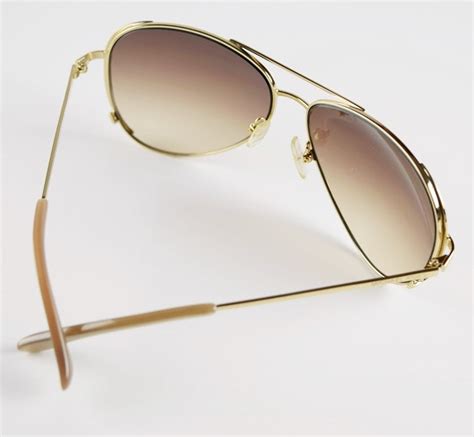 michael kors ladies aviator style sunglasses with gold rims made in sicily ebth