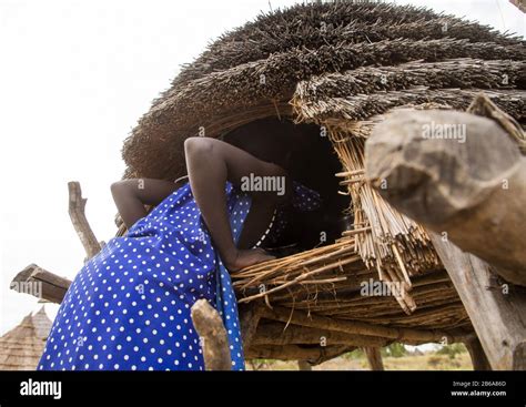 Toposa Tribe Girl Climbing In A Granary In A Village Namorunyang State