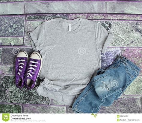 gray  shirt mockup flat lay  purple brick background  purple shoes  ripped jeans stock