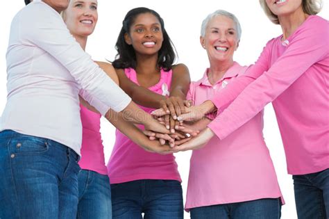 Women Wearing Pink And Ribbons For Breast Cancer Holding Hands I Stock