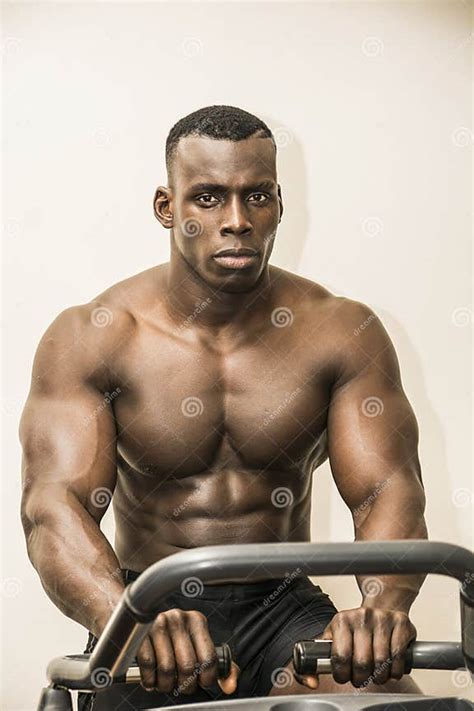 muscular black bodybuilder exercising on stationary bike in gym stock image image of shirtless