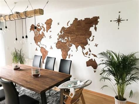 A Dining Room Table With Chairs And A Wooden World Map On The Wall
