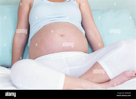 Pregnant Woman Sitting On Bed Stock Photo Alamy