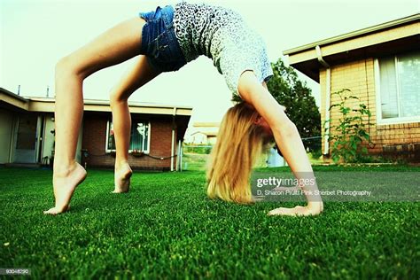 Girl Bending Over Backwards Arch In Grass High Res Stock Photo Getty