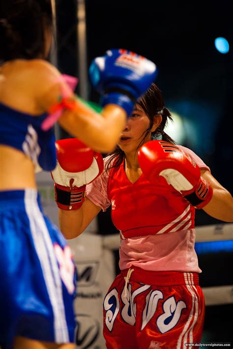 Female Muay Thai Kickboxing A Female Muay Thai Kickboxer Receives A Kick Sending Sweat Flying