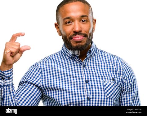 African American Man With Beard Holding Something Very Tiny Size