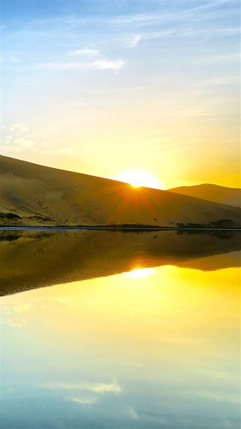 Desert Reflection On River During Sunrise Under Blue Sky