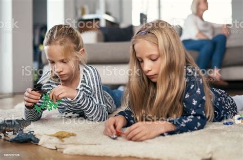 Shot Of Two Sisters Playing Together In Their Living Room Stock Photo