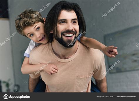Portrait Happy Father Little Son Pointing Away While Piggybacking