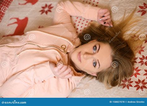 beautiful girl lying on her back in bed royalty free stock image 158827078