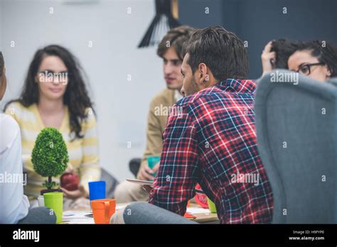 Group of young business professionals having a meeting Stock Photo - Alamy