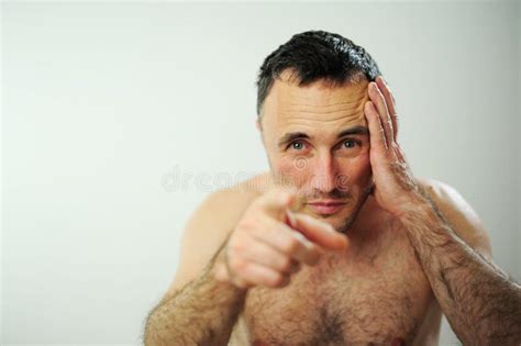 Man With A Naked Torso And Hairy Arms With One Hand Held At The Temple On The Head Adult