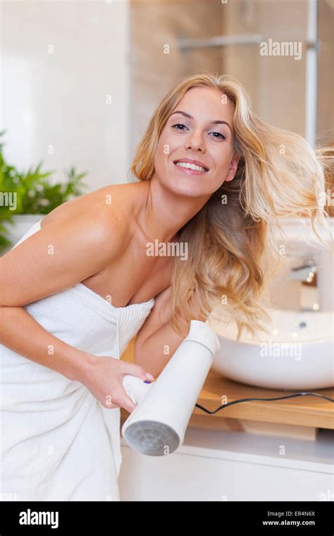 Blonde Woman Drying Hair After The Shower Debica Poland Stock Photo
