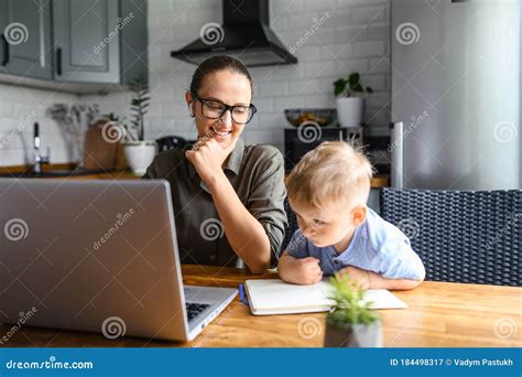 Young Mother Works From Home With Laptop Stock Image Image Of Busy