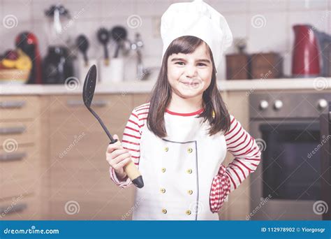 Cute Little Girl Chef Posing In The Kitchen Stock Photo Image Of Girl