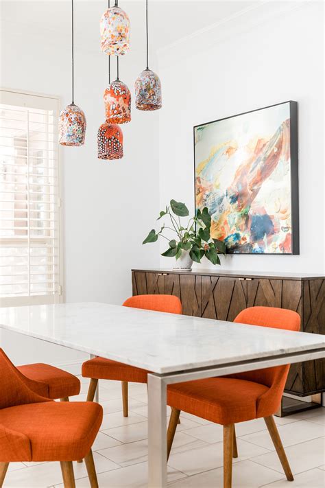 Dining Rooms With Orange Accents Upholstered Chairs And Blown Glass