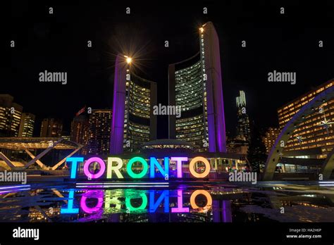 Toronto Sign With The Illuminated City Hall At Night In Toronto