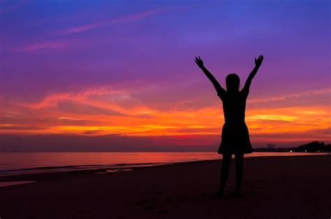 Premium Photo Silhouette Of Woman With Hands Up While Standing On Sea