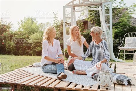 Three Women Enjoying Outdoors Talking And Laughing Stock Photo - Download Image Now - iStock