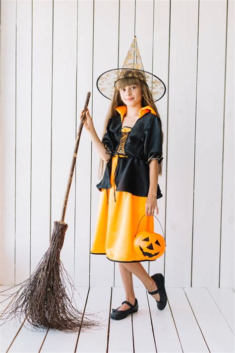 Free Photo Girl In Halloween Costume With Broom Posing In Studio