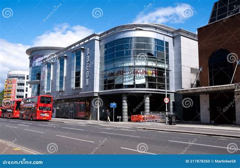 modern architecture of a town centre odeon cinema with two red busses and no people editorial