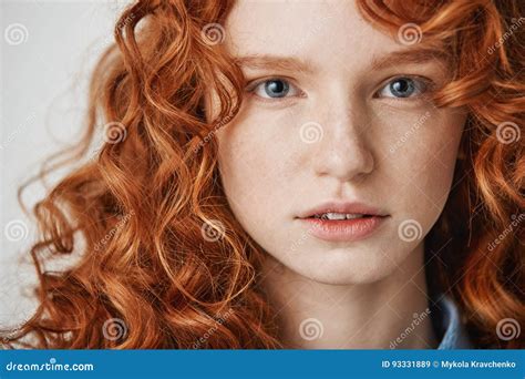 Close Up Of Beautiful Natural Ginger Girl With Freckles Looking At