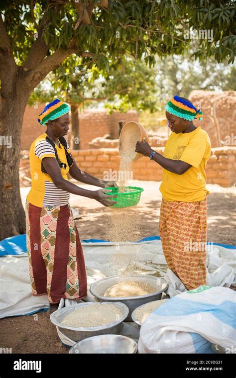 Two Women Sift Their Sesame Seed Crop Together In Rural Village In