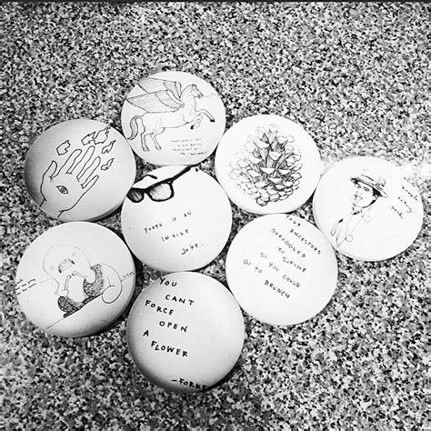 Six Eggs With Drawings On Them Are Sitting On The Ground Next To Each
