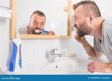 Man Brushing His Teeth In Bathroom Stock Photo Image Of Reflection