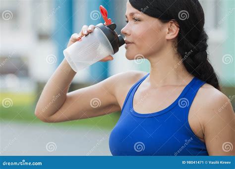 Beautiful Fitness Athlete Woman Resting Drinking Water After Work Out