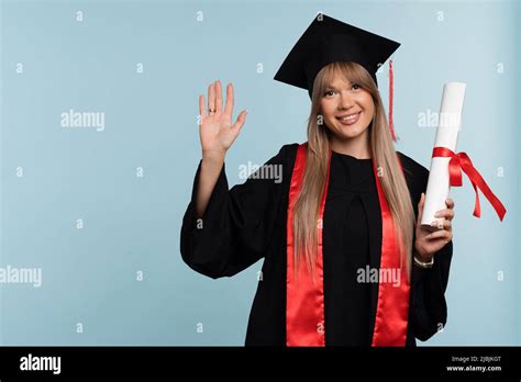Girl Graduate In Graduation Hat With Diploma On Light Blue Background