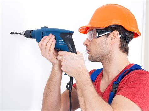 A Man Drilling A Hole In The Wall Stock Photo Image Of Employee