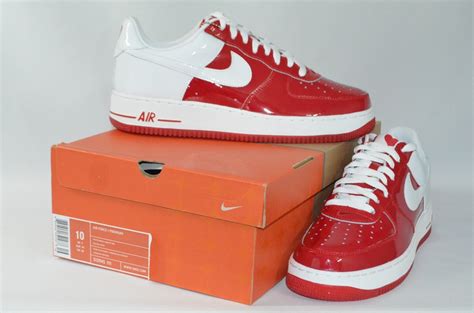The nike air force 1s include tongues that can pop open and closed with buttons, reading: CC: Air Force 1 Low Premium "Valentine's Day" 312945-111
