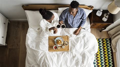 African American Couple In Bed Having A Breakfast In Bed Cosy Homes