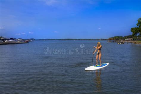 Beautiful Bikini Model Relaxing On A Boat By The Docks Stock Photo