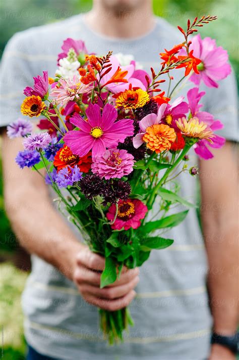 Man Holding A Bunch Of Flowers Stocksy United