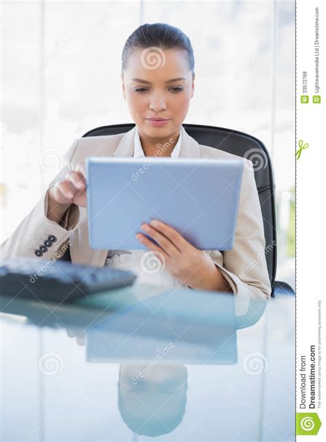 Focused Sophisticated Businesswoman Holding Tablet Computer Stock Photo