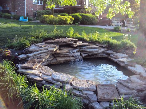 Set up your pond next to a fence, and include a covered seating area. landscaping around a pond | ... flow back to the pond. the ...