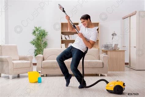Man Cleaning Home With Vacuum Cleaner Stock Photo Crushpixel