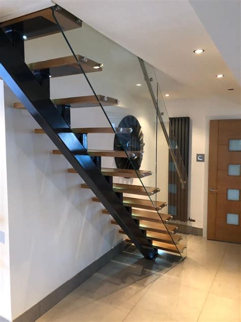 Feature Central Spine Staircase With Solid Oak Treads And Glass